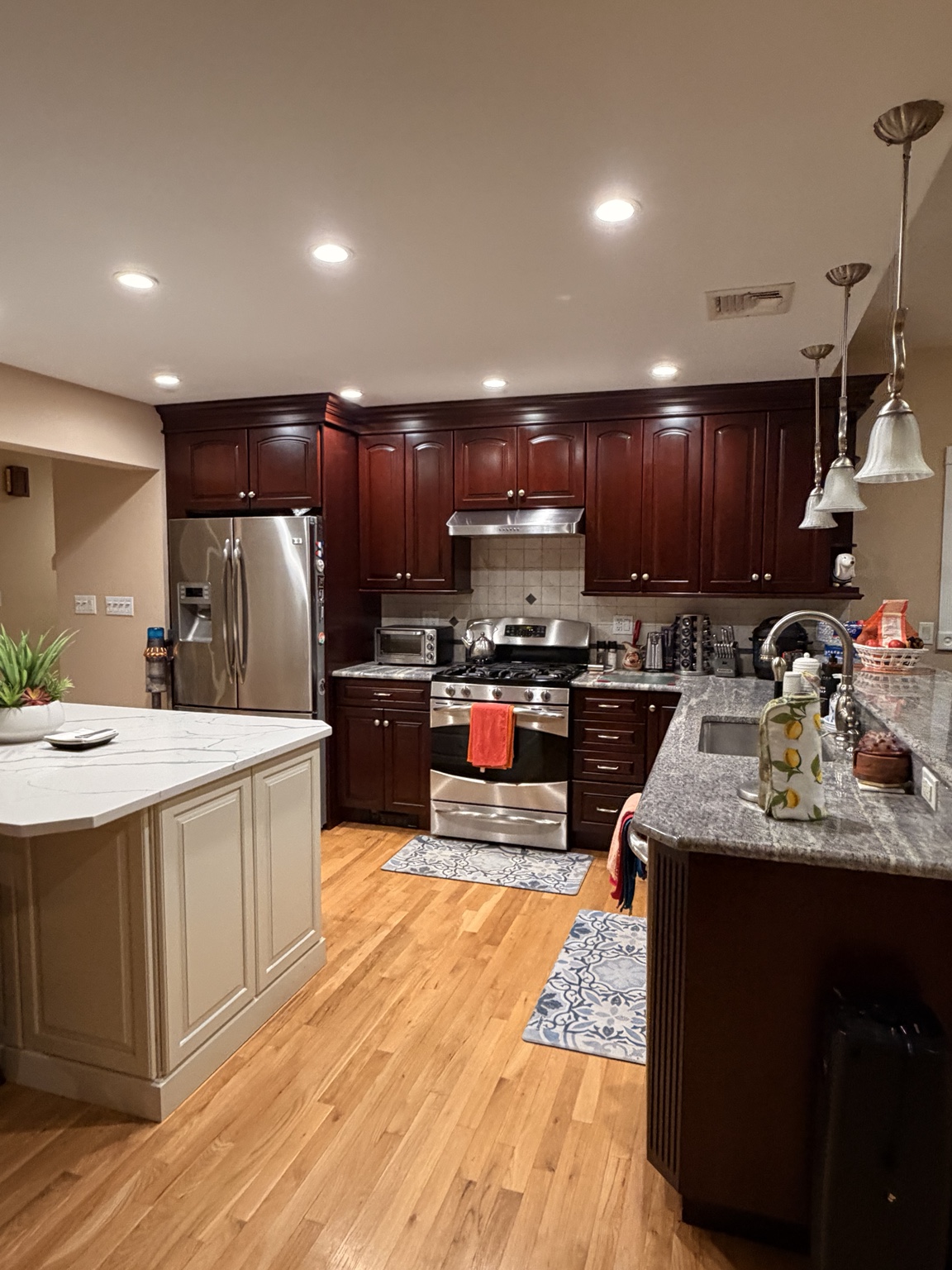 A cared-for home kitchen with polished wood floors and clear work surfaces