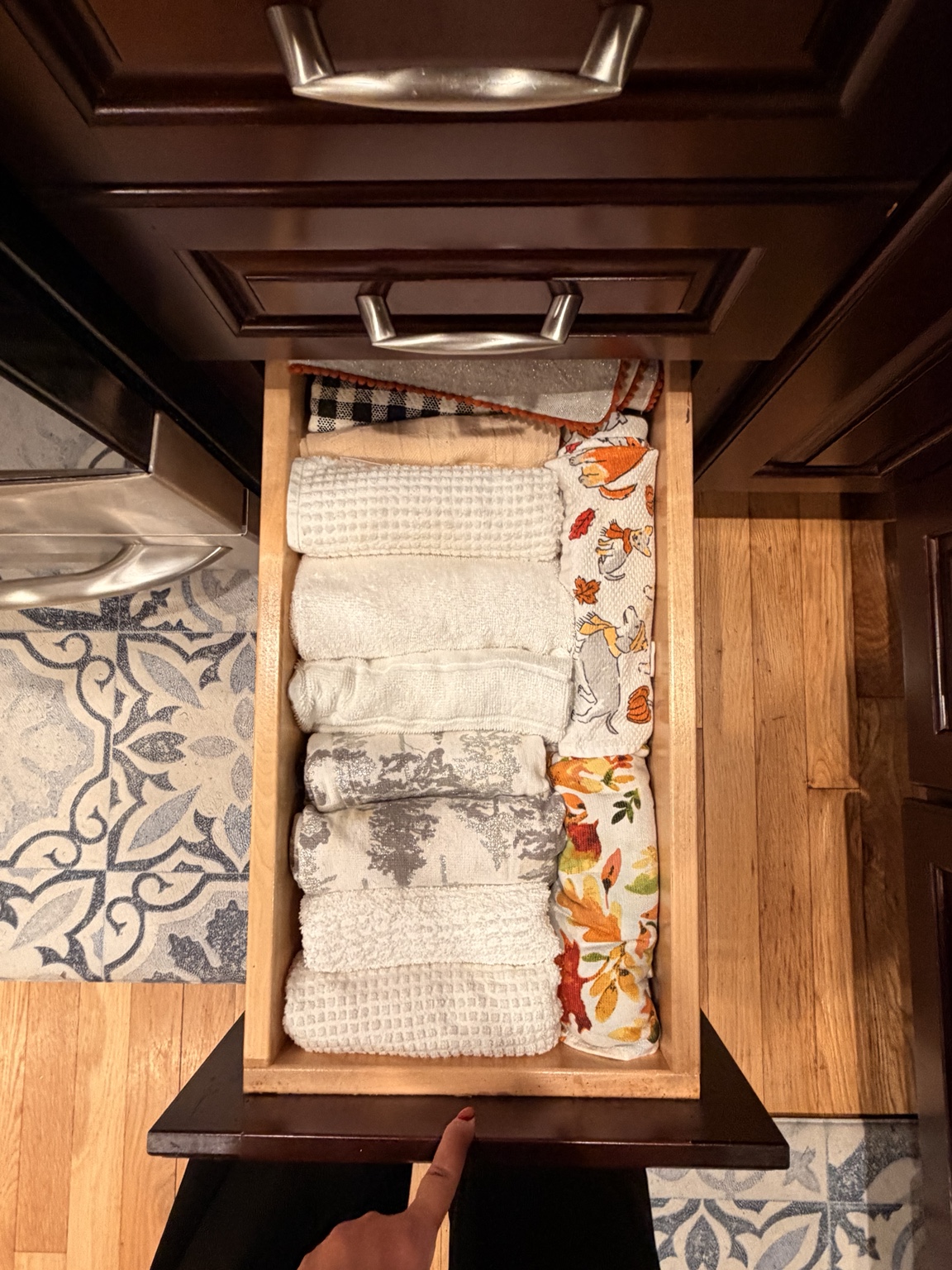 Kitchen drawer with neatly folded and rolled dish towels